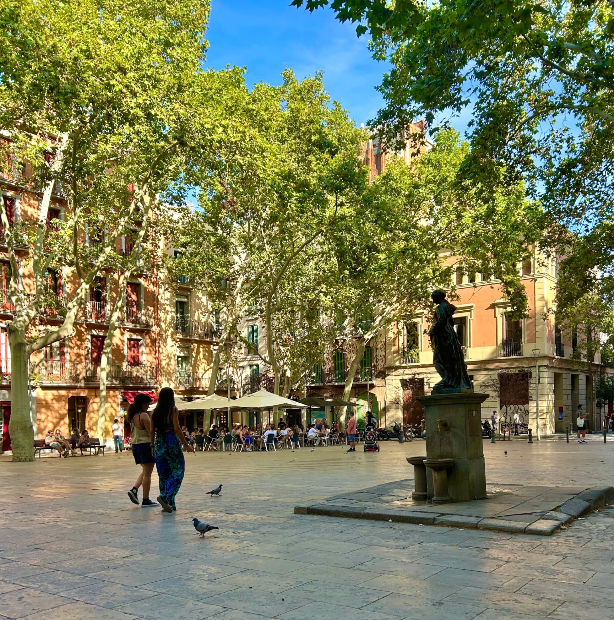 Locals sitting outside in a plaça in Gràcia, Barcelona